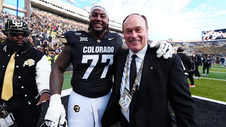 Oct 11, 2025; Boulder, Colorado, USA; Colorado Buffaloes offensive lineman Jordan Seaton (77) and athletic director Rick George following the win against the Iowa State Cyclones  at Folsom Field. Mandatory Credit: Ron Chenoy-Imagn Images