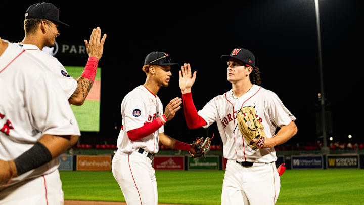 Roman Anthony high fives WooSox teammates following the Triple-A club's 12-2 win over Toledo on Tuesday at Polar Park.