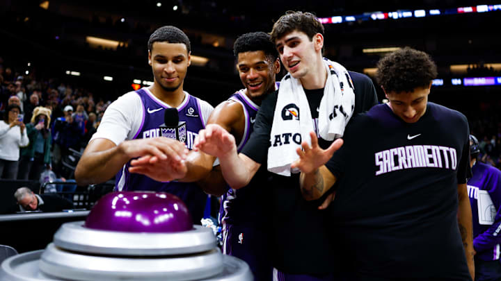 Dec 21, 2025; Sacramento, California, USA; Sacramento Kings forward Keegan Murray (13) and center Dylan Cardwell (32) and center Maxime Raynaud (42) and guard Nique Clifford (5) prepare to light the beam in celebration of their win against the Houston Rockets at Golden 1 Center. Mandatory Credit: Sergio Estrada-Imagn Images