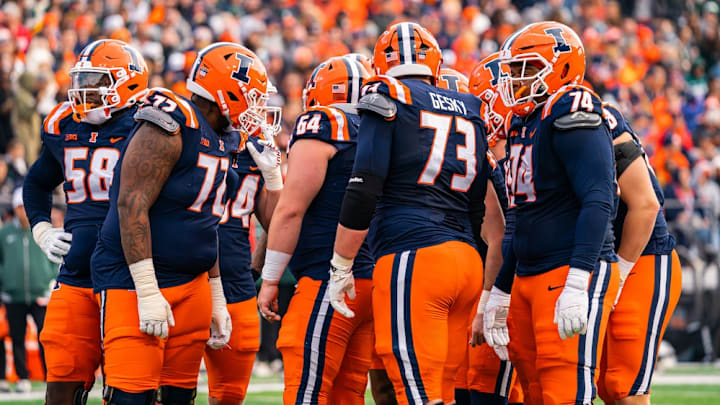 Members of Illinois' offensive line huddle against Michigan State on Saturday at Memorial Stadium. The group helped the Illini hold the Spartans to zero sacks and run for 138 yards in a 38-16 win.