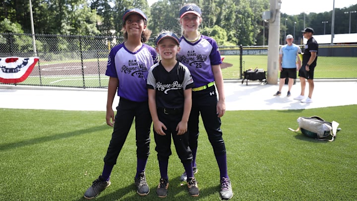 Ellery Thomas (r.) with some teammates in front of the new Rhyne Park softball fields.
