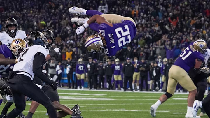 Cam Davis catapults into the end zone to score against Colorado in 2022. Cam Davis catapults into the end zone to score against Colorado in 2022.