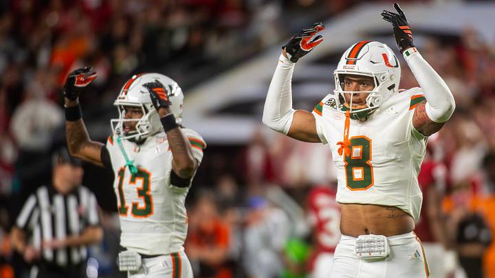 Miami's Jakobe Thomas (8) and Bryce Fitzgerald (13) get the crowd hyped during the College Football Playoff National Championship college football game at Hard Rock Stadium in Miami Gardens on Monday, Jan. 19, 2026.