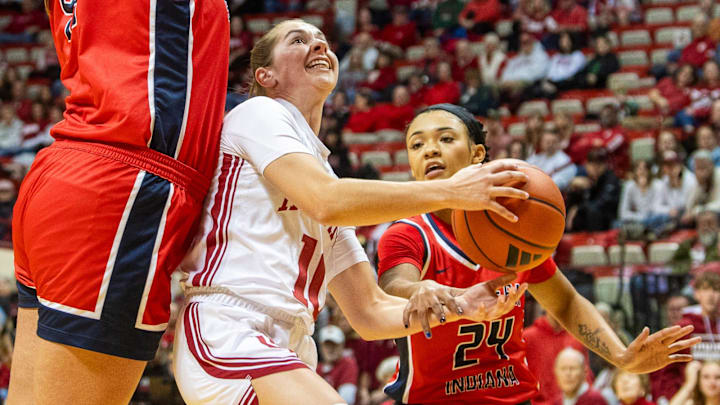 Indiana's Shay Ciezki (10) is fouled by Southern Indiana's Amiyah Buchanan (24) during the Indiana versus Southern Indiana women's basketball game at Simon Skjodt Assembly Hall on Tuesday, Dec. 3, 2024.
