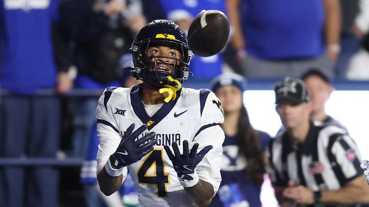 Oct 3, 2025; Provo, Utah, USA; West Virginia Mountaineers wide receiver Cam Vaughn (4) makes a catch for a touchdown against the Brigham Young Cougars during the fourth quarter at LaVell Edwards Stadium. Mandatory Credit: Rob Gray-Imagn Images Oct 3, 2025; Provo, Utah, USA; West Virginia Mountaineers wide receiver Cam Vaughn (4) makes a catch for a touchdown against the Brigham Young Cougars during the fourth quarter at LaVell Edwards Stadium. Mandatory Credit: Rob Gray-Imagn Images