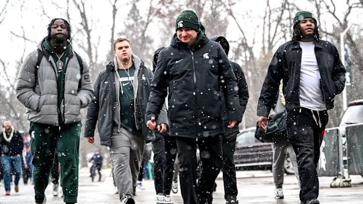 Michigan State's head coach Jonathan Smith, center, and the football team enter Spartan Stadium before the game against Rutgers on Saturday, Nov. 30, 2024, in East Lansing.
