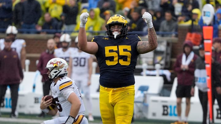 Michigan defensive lineman Mason Graham celebrates after sacking Minnesota quarterback Max Brosmer, in the background, during first-half action between Michigan and Minnesota at Michigan Stadium in Ann Arbor on Saturday, Sept. 28, 2024.