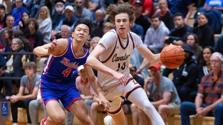 Lake Travis Cavaliers forward Hudson Greer drives against the Westlake Chaparrals during the first period of the Class Texas 6A District-26 boys basketball game on Tuesday, Dec 6, 2022, at Lake Travis High School in Lakeway, TX.