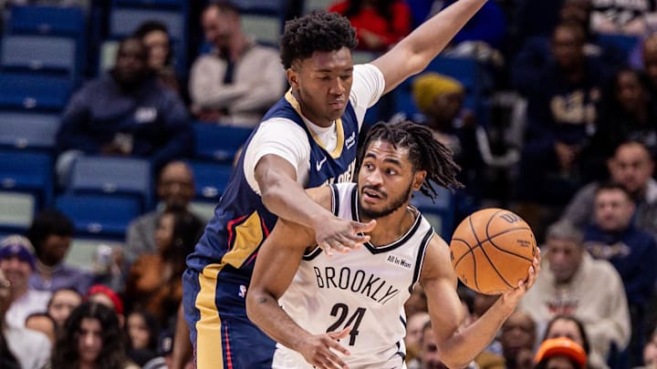 Jan 14, 2026; New Orleans, Louisiana, USA;  Brooklyn Nets guard Cam Thomas (24) passes the ball against New Orleans Pelicans center Derik Queen (22) during the second half at Smoothie King Center. Mandatory Credit: Stephen Lew-Imagn Images