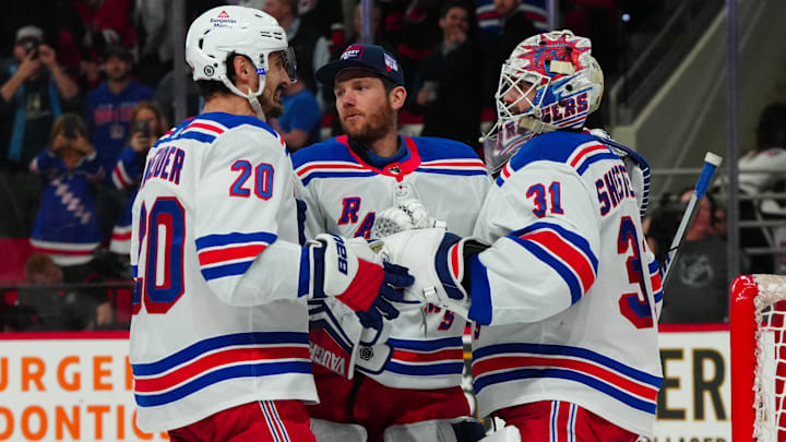 Mar 12, 2024; Raleigh, North Carolina, USA; New York Rangers goaltender Igor Shesterkin (31) goaltender Jonathan Quick (32) and left wing Chris Kreider (20) celebrate their victory against the Carolina Hurricanes at PNC Arena. Mandatory Credit: James Guillory-Imagn Images