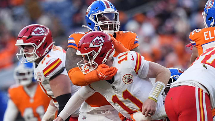 Jan 5, 2025; Denver, Colorado, USA; Denver Broncos defensive end John Franklin-Myers (98) hits Kansas City Chiefs quarterback Carson Wentz (11) in the second half at Empower Field at Mile High. Mandatory Credit: Ron Chenoy-Imagn Images