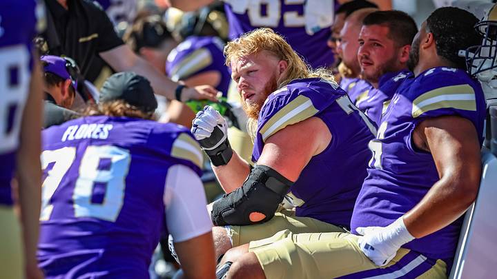John Mills, center, sits with his fellow UW offensive linemen during the Apple Cup, including Kodi Greene, right. John Mills, center, sits with his fellow UW offensive linemen during the Apple Cup, including Kodi Greene, right.