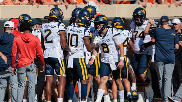 Oct 5, 2024; Stillwater, Oklahoma, USA; West Virginia Mountaineers quarterback Nicco Marchiol (8) celebrates after a touchdown against the Oklahoma State Cowboys during the first quarter at Boone Pickens Stadium. Mandatory Credit: William Purnell-Imagn Images