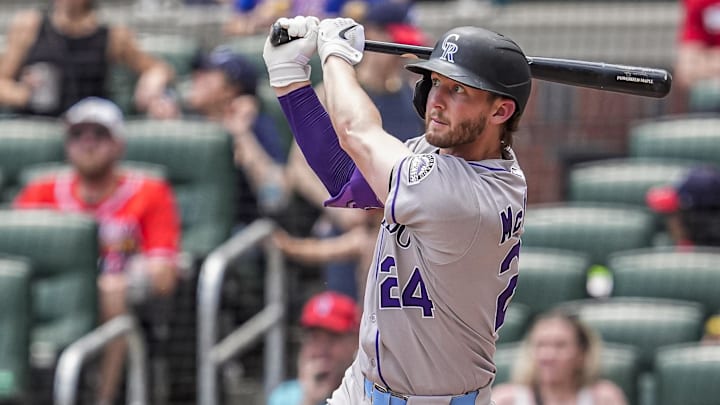 Jun 15, 2025; Cumberland, Georgia, USA; Colorado Rockies third baseman Ryan McMahon (24) hits a home run against the Atlanta Braves during the seventh inning at Truist Park. 