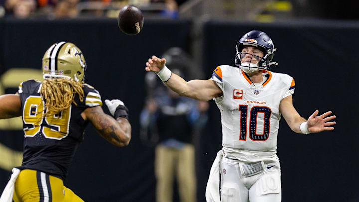 Oct 17, 2024; New Orleans, Louisiana, USA; Denver Broncos quarterback Bo Nix (10) passes over New Orleans Saints defensive end Chase Young (99) during the first half at Caesars Superdome. Oct 17, 2024; New Orleans, Louisiana, USA; Denver Broncos quarterback Bo Nix (10) passes over New Orleans Saints defensive end Chase Young (99) during the first half at Caesars Superdome.