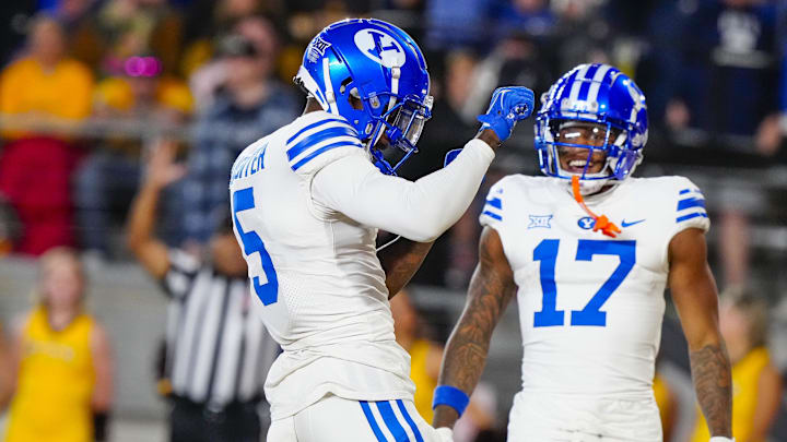 Sep 14, 2024; Laramie, Wyoming, USA; Brigham Young Cougars wide receiver Darius Lassiter (5) celebrates after scoring a touchdown against the Wyoming Cowboys during the third quarter at Jonah Field at War Memorial Stadium.