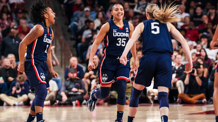 Feb 16, 2025; Columbia, South Carolina, USA; UConn Huskies guard KK Arnold (2), guard Azzi Fudd (35) and guard Paige Bueckers (5) celebrate a three point basket against the South Carolina Gamecocks in the first half at Colonial Life Arena. Mandatory Credit: Jeff Blake-Imagn Images Feb 16, 2025; Columbia, South Carolina, USA; UConn Huskies guard KK Arnold (2), guard Azzi Fudd (35) and guard Paige Bueckers (5) celebrate a three point basket against the South Carolina Gamecocks in the first half at Colonial Life Arena. Mandatory Credit: Jeff Blake-Imagn Images