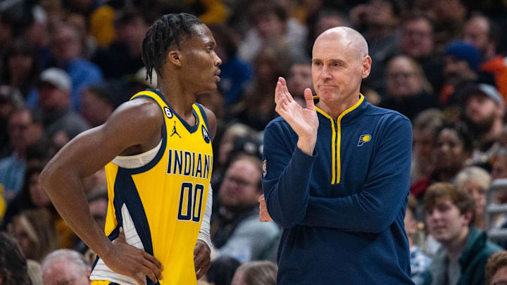 Dec 9, 2022; Indianapolis, Indiana, USA; Indiana Pacers guard Bennedict Mathurin (00) and head coach Rick Carlisle talk in the second half against the Washington Wizards at Gainbridge Fieldhouse. Mandatory Credit: Trevor Ruszkowski-Imagn Images