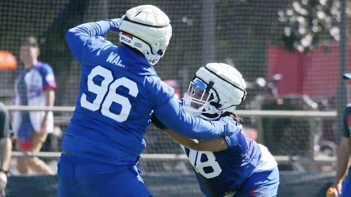 Bills rookie tackles T.J. Sanders, right, and Deone Walker lock up during drills during the opening day of Buffalo Bills training camp at St. John Fisher University Wednesday, July 23, 2025 in Pittsford.