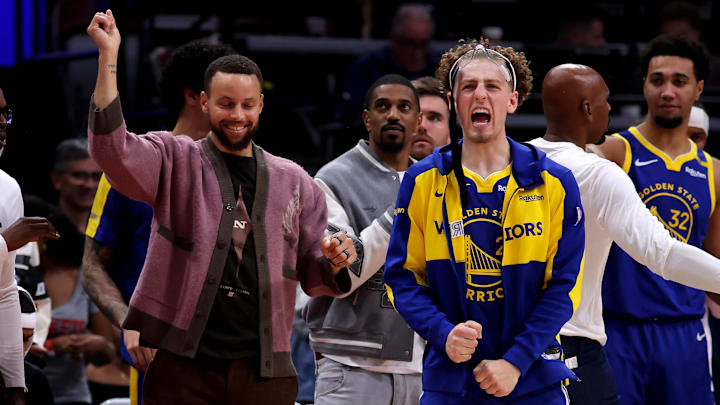 Nov 2, 2024; Houston, Texas, USA; Golden State Warriors guards Stephen Curry and guard Brandin Podziemski (2) react on the bench after a made basket against the Houston Rockets during the overtime period at Toyota Center. Mandatory Credit: Erik Williams-Imagn Images
