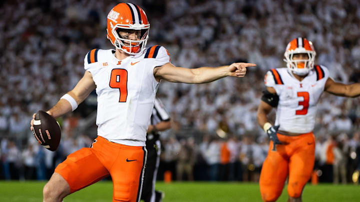 Illinois quarterback Luke Altmyer (9) points to one of his blockers as he runs with the ball in the second quarter of a Big Ten football game against Penn State, Saturday, Sept. 28, 2024, in State College, Pa. Illinois quarterback Luke Altmyer (9) points to one of his blockers as he runs with the ball in the second quarter of a Big Ten football game against Penn State, Saturday, Sept. 28, 2024, in State College, Pa.