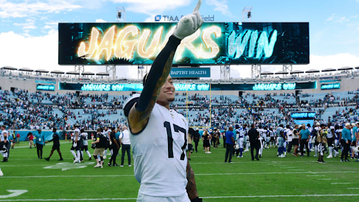 Jacksonville Jaguars tight end Evan Engram (17) points to the fans in the stands as he walks off the field. 
