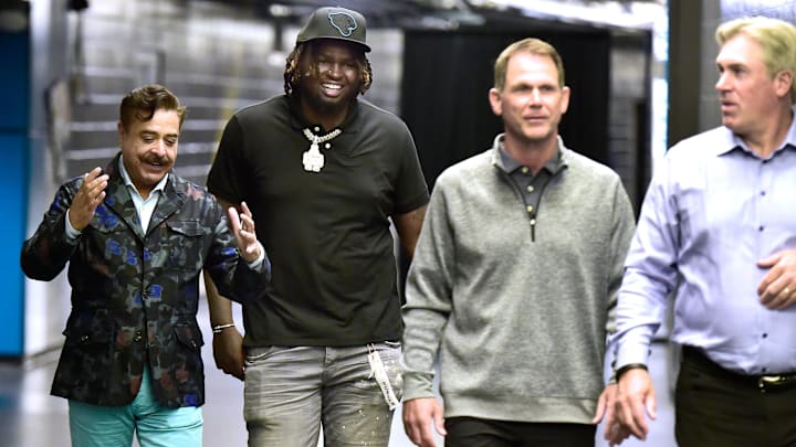 Jaguars owner Shad Khan talks with the team's first round draft pick Anton Harrison as they walk.