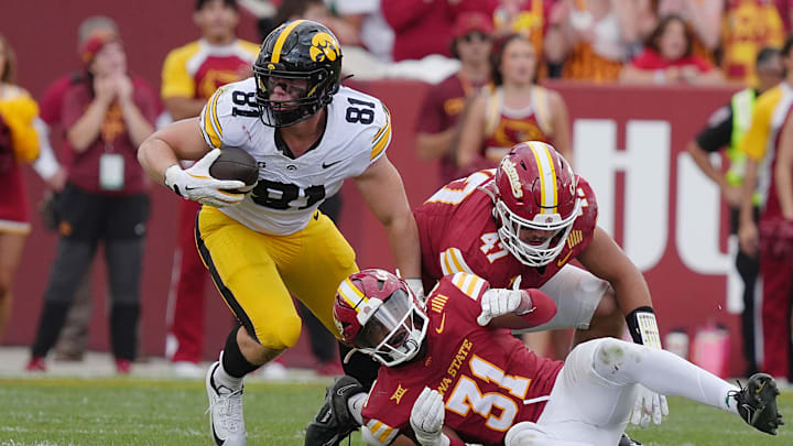 Iowa Hawkeyes tight end DJ Vonnahme (81) makes a catch around Iowa State Cyclones' defensive back Marcus Neal Jr.(31) and linebacker Kooper Ebel (47) during the fourth quarter in the Cy-Hawk football at Jack Trice Stadium on Sept. 6, 2025, in Ames, Iowa