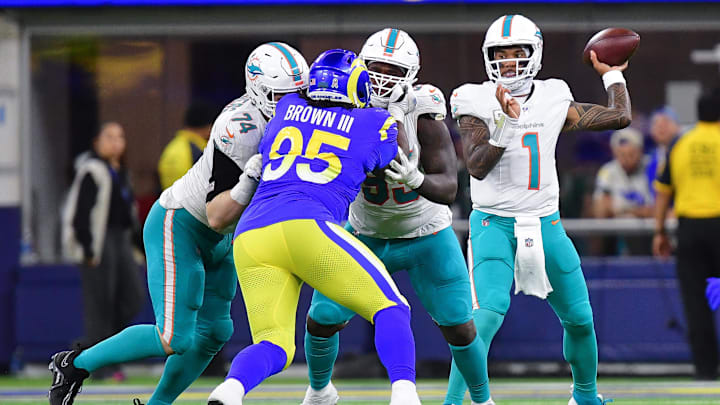 Miami Dolphins quarterback Tua Tagovailoa (1) throws as Los Angeles Rams defensive tackle Bobby Brown III (95) moves in during the second half at SoFi Stadium. Miami Dolphins quarterback Tua Tagovailoa (1) throws as Los Angeles Rams defensive tackle Bobby Brown III (95) moves in during the second half at SoFi Stadium.