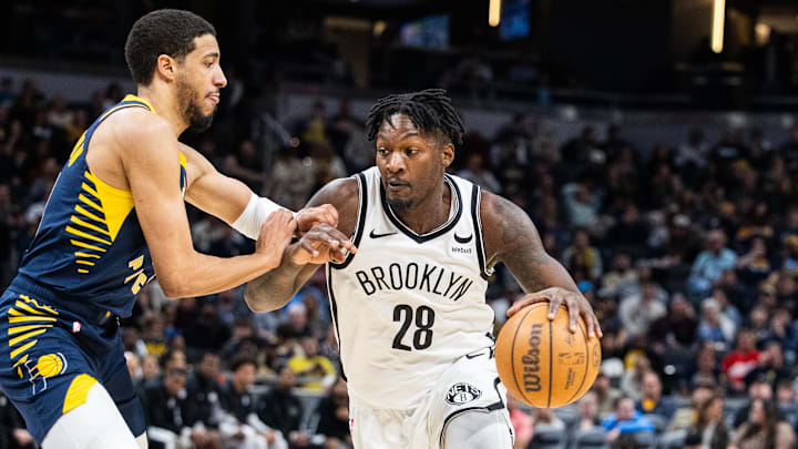 Apr 1, 2024; Indianapolis, Indiana, USA; Brooklyn Nets forward Dorian Finney-Smith (28) dribbles the ball while Indiana Pacers guard Tyrese Haliburton (0) defends in the second half at Gainbridge Fieldhouse. Mandatory Credit: Trevor Ruszkowski-Imagn Images