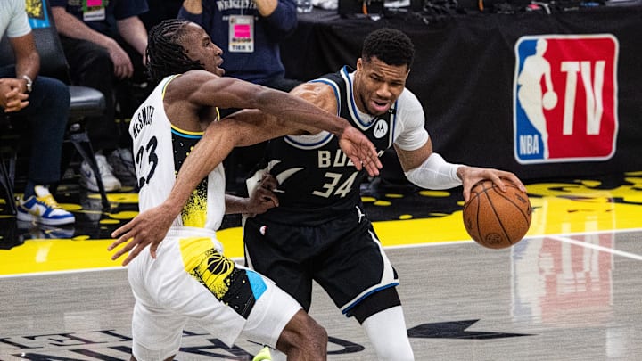 Apr 22, 2025; Indianapolis, Indiana, USA; Milwaukee Bucks forward Giannis Antetokounmpo (34) dribbles the ball while Indiana Pacers forward Aaron Nesmith (23) defends during game two of first round for the 2024 NBA Playoffs at Gainbridge Fieldhouse. Mandatory Credit: Trevor Ruszkowski-Imagn Images