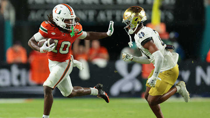 Aug 31, 2025; Miami Gardens, Florida, USA; Miami Hurricanes wide receiver Malachi Toney (10) runs with the football against Notre Dame Fighting Irish cornerback Karson Hobbs (21) during the first half at Hard Rock Stadium. Mandatory Credit: Sam Navarro-Imagn Images