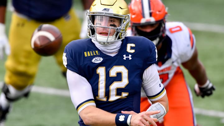 Dec 5, 2020; South Bend, Indiana, USA; Notre Dame Fighting Irish quarterback Ian Book (12) throws in the second quarter against the Syracuse Orange at Notre Dame Stadium. Dec 5, 2020; South Bend, Indiana, USA; Notre Dame Fighting Irish quarterback Ian Book (12) throws in the second quarter against the Syracuse Orange at Notre Dame Stadium.