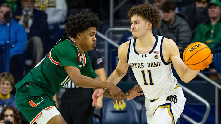 Jan 13, 2026; South Bend, Indiana, USA; Notre Dame Fighting Irish guard Braeden Shrewsberry (11) looks to pass as Miami (FL) Hurricanes guard Tru Washington (10) defends during the second half at Purcell Pavilion at the Joyce Center. 