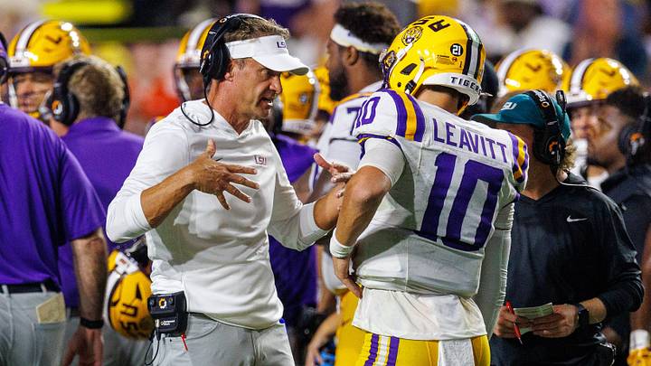 LSU Tigers head coach Lane Kiffin talks to quarterback Sam Leavitt (10) against Clemson Tigers during the first half at Tiger Stadium.  