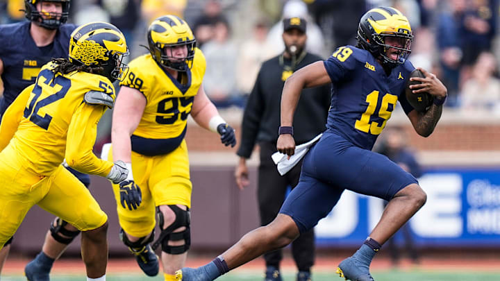 Team Blue quarterback Bryce Underwood (19) runs against Team Maize during the second half of the spring game at Michigan Stadium in Ann Arbor on Saturday, April 19, 2025.