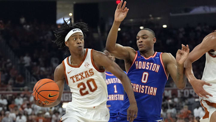Nov 8, 2024; Austin, Texas, USA; Texas Longhorns guard Tre Johnson (20) drives against Houston Christian Huskies guard Demari Williams (0) during the first half at Moody Center. Mandatory Credit: Scott Wachter-Imagn Images