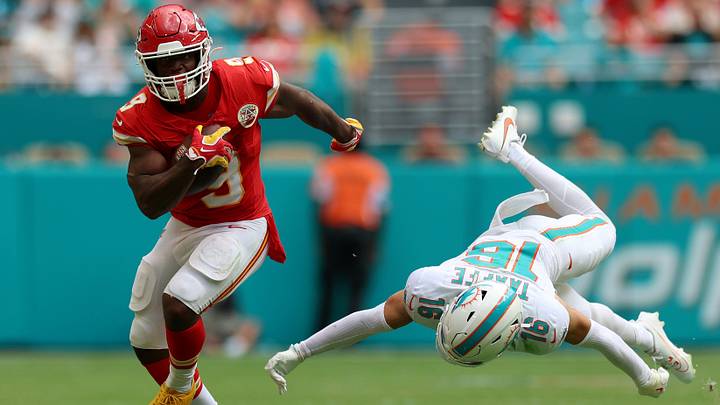 Sep 27, 2026; Miami Gardens, Florida, USA;  Kansas City Chiefs running back Kenneth Walker III (9) stiff arms Miami Dolphins safety Michael Taaffe (16) during the fourth quarter at Hard Rock Stadium.  Mandatory Credit: Nathan Ray Seebeck-Imagn Images