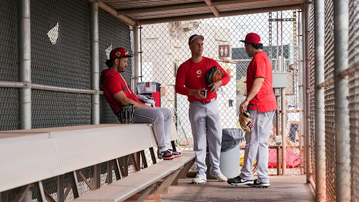 From left, Cincinnati Reds infielders Eugenio Suárez (28), Nathaniel Lowe (31) and Sal Stewart (27) share a conversation during the first day of full squad workouts , Monday, Feb. 16, 2026, at the Cincinnati Reds player development complex in Goodyear, Ariz.