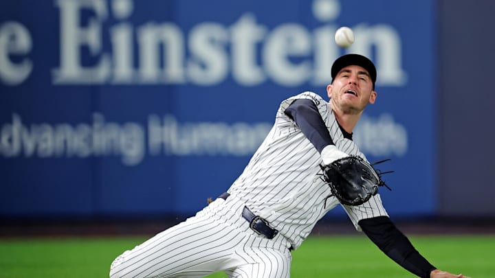 Oct 8, 2025; Bronx, New York, USA; New York Yankees left fielder Cody Bellinger (35) slides to makes a catch during the first inning against the Toronto Blue Jays during game four of the ALDS round for the 2025 MLB playoffs at Yankee Stadium. Mandatory Credit: Brad Penner-Imagn Images
