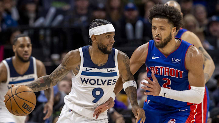Mar 27, 2024; Minneapolis, Minnesota, USA; Minnesota Timberwolves guard Nickeil Alexander-Walker (9) dribbles the ball as Detroit Pistons guard Cade Cunningham (2) plays defense in the second half at Target Center. Mandatory Credit: Jesse Johnson-Imagn Images