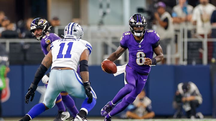 Sep 22, 2024; Arlington, Texas, USA; Baltimore Ravens quarterback Lamar Jackson (8) runs with Dallas Cowboys linebacker Micah Parsons (11) closing during the second quarter at AT&T Stadium. Mandatory Credit: Andrew Dieb-Imagn Images Sep 22, 2024; Arlington, Texas, USA; Baltimore Ravens quarterback Lamar Jackson (8) runs with Dallas Cowboys linebacker Micah Parsons (11) closing during the second quarter at AT&T Stadium. Mandatory Credit: Andrew Dieb-Imagn Images