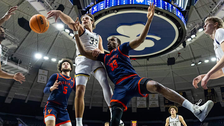 Jan 27, 2026; South Bend, Indiana, USA; Notre Dame Fighting Irish forward Carson Towt (33) and Virginia Cavaliers center Ugonna Onyenso (33) fight for a rebound during the first half at Purcell Pavilion at the Joyce Center. Mandatory Credit: Michael Caterina-Imagn Images