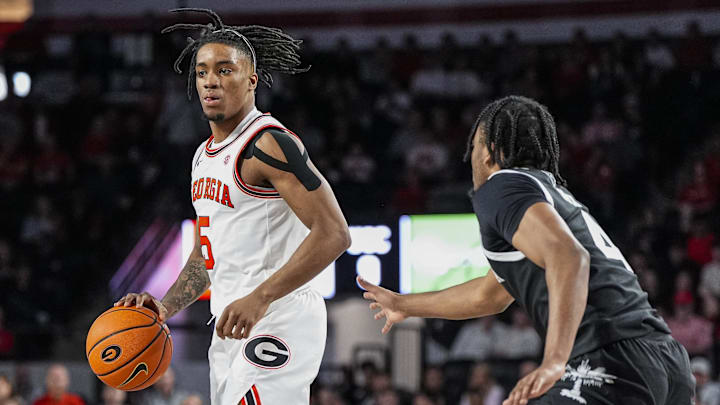 Feb 28, 2026; Athens, Georgia, USA; Georgia Bulldogs guard Jeremiah Wilkinson (5) dribbles against South Carolina Gamecocks guard Kobe Knox (4) during the first half at Stegeman Coliseum. Mandatory Credit: Dale Zanine-Imagn Images