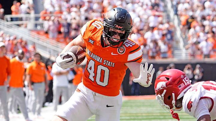 Oklahoma State's Josh Ford (40) looks to get past Arkansas' Jaheim Singletary (15) in the second half of the college football game between the Oklahoma State Cowboys and the Arkansas Razorbacks at Boone Pickens Stadium in Stillwater, Okla.,, Saturday, Sept., 7, 2024. Oklahoma State's Josh Ford (40) looks to get past Arkansas' Jaheim Singletary (15) in the second half of the college football game between the Oklahoma State Cowboys and the Arkansas Razorbacks at Boone Pickens Stadium in Stillwater, Okla.,, Saturday, Sept., 7, 2024.