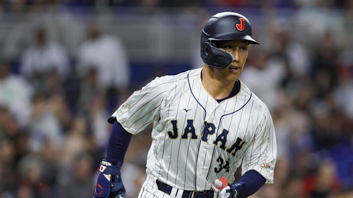 Mar 20, 2023; Miami, Florida, USA; Japan left fielder Masataka Yoshida (34) runs toward first base after a base hit during the second inning against Mexico at LoanDepot Park. Mandatory Credit: Sam Navarro-Imagn Images