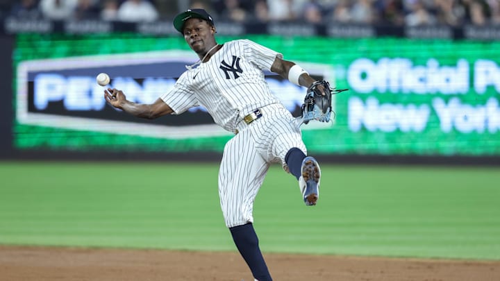Apr 15, 2025; Bronx, New York, USA;  New York Yankees second baseman Jazz Chisholm Jr. (13) tries to make a running throw to first base in the fifth inning against the Kansas City Royals at Yankee Stadium. All players wore #42 for Jackie Robinson Day.  Mandatory Credit: Wendell Cruz-Imagn Images