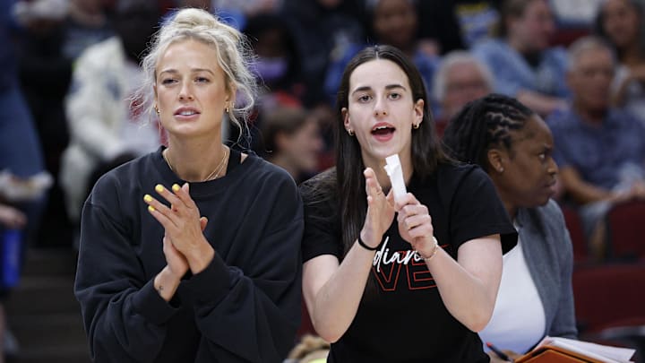 Jun 7, 2025; Chicago, Illinois, USA; Injured Indiana Fever guard Sophie Cunningham (8) and guard Caitlin Clark (22) react from the bench during the first half of a WNBA game against the Chicago Sky at United Center. Mandatory Credit: Kamil Krzaczynski-Imagn Images