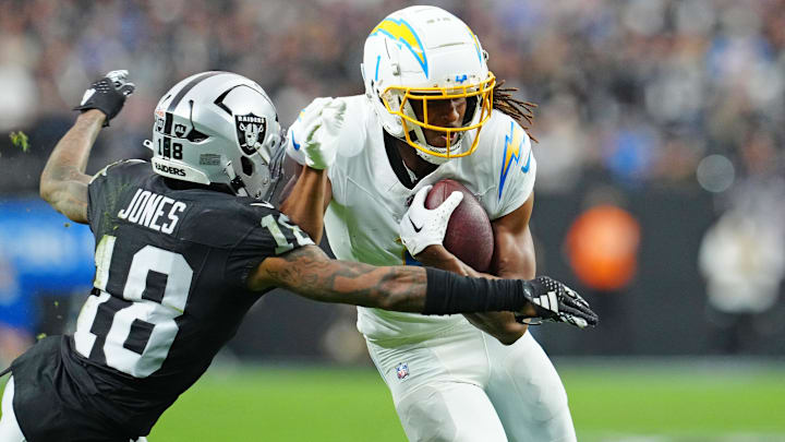 Chargers WR Quentin Johnston carries the ball against the Raiders