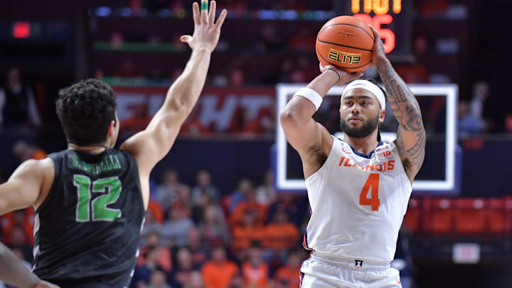 Dec 29, 2024; Champaign, Illinois, USA;  Illinois Fighting Illini guard Kylan Boswell (4) shoots the ball over Chicago State Cougars guard Gabe Spinelli (12) during the first half at State Farm Center. Mandatory Credit: Ron Johnson-Imagn Images